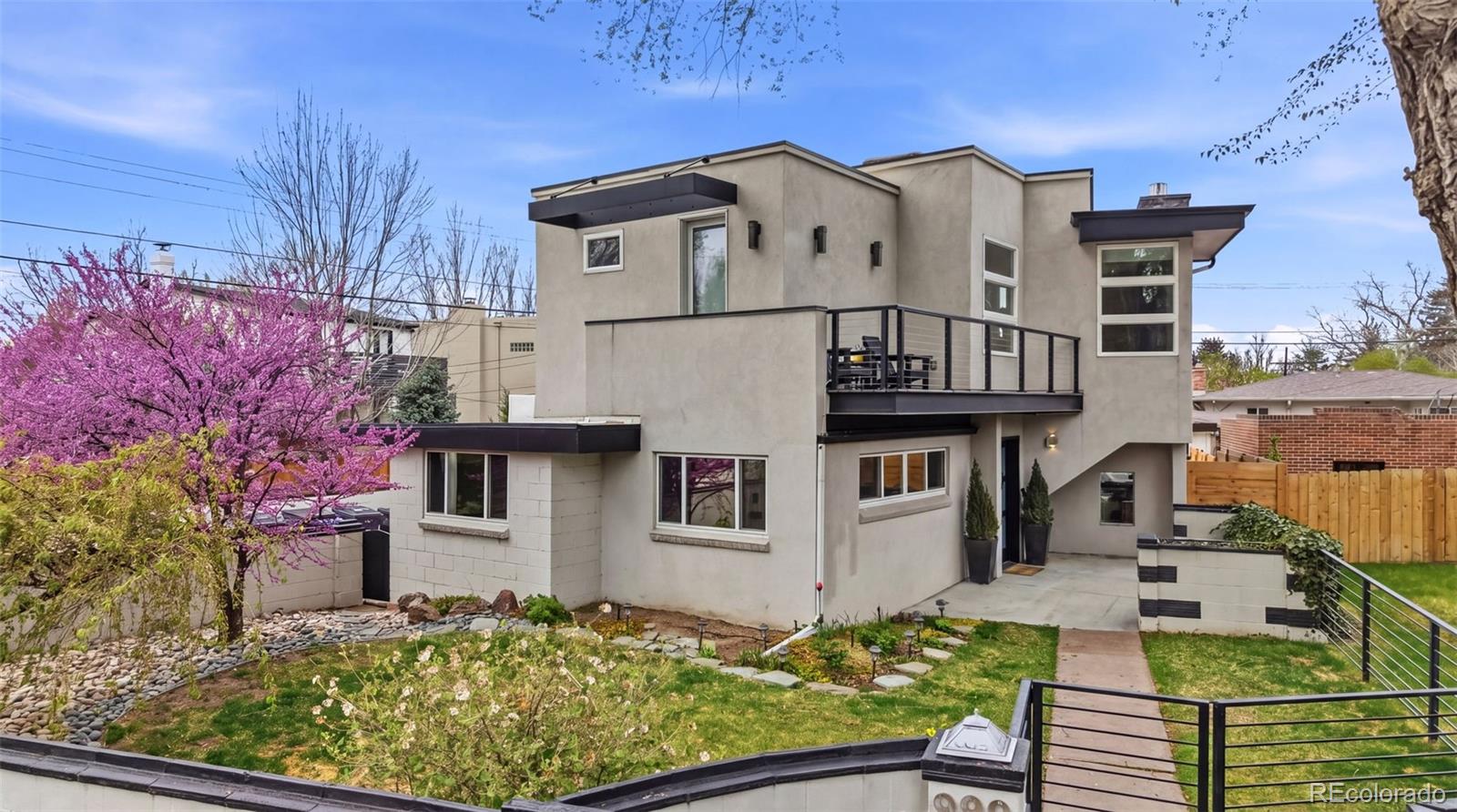 999 South Fillmore Way Denver, CO 80209 - Photo 1 of 37 a front view of a house with garden