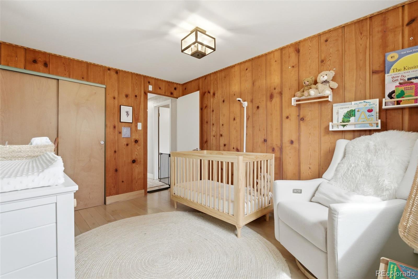 999 South Fillmore Way Denver, CO 80209 - Photo 19 of 37 a living room with furniture and a baby crib