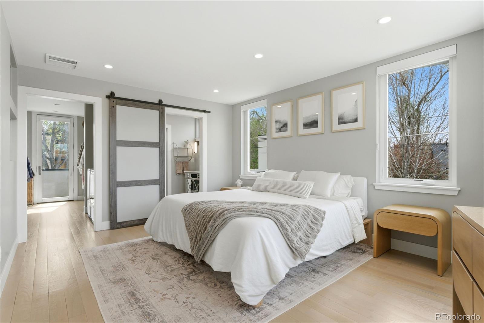 999 South Fillmore Way Denver, CO 80209 - Photo 26 of 37 a spacious bedroom with a large bed and a couch