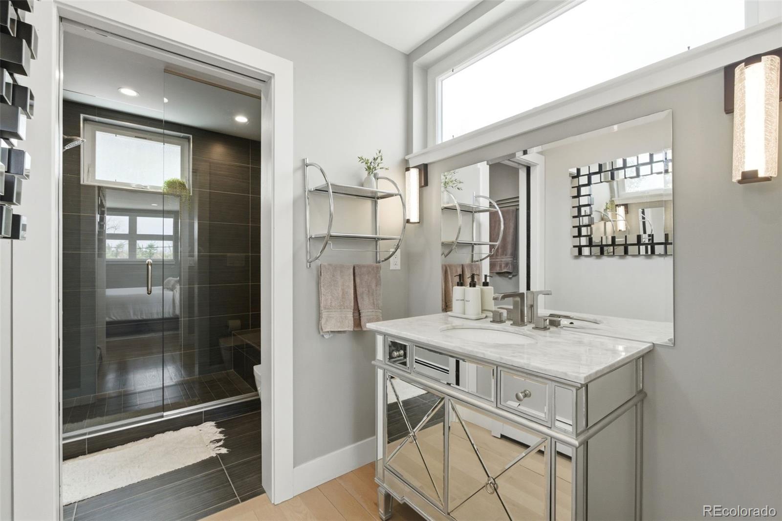 999 South Fillmore Way Denver, CO 80209 - Photo 28 of 37 a bathroom with a sink mirror and a shower