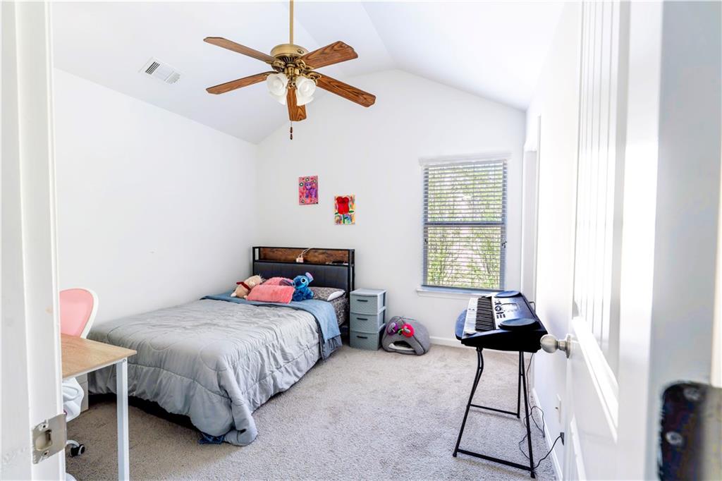 5555 Hedge Brook Drive Cumming, GA 30028 - Photo 11 of 15 a bedroom with a bed and a chandelier