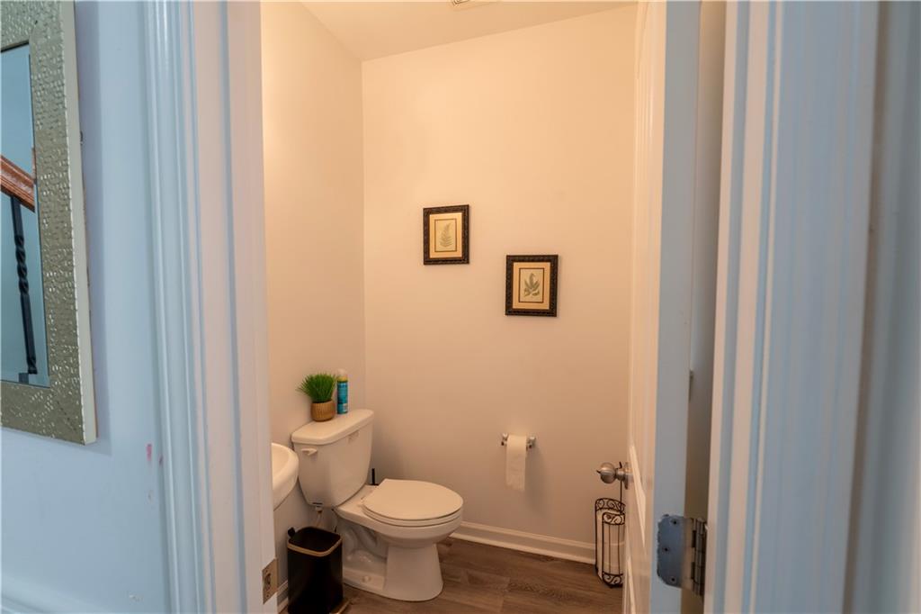 5555 Hedge Brook Drive Cumming, GA 30028 - Photo 13 of 15 a white toilet sitting next to a bathroom sink