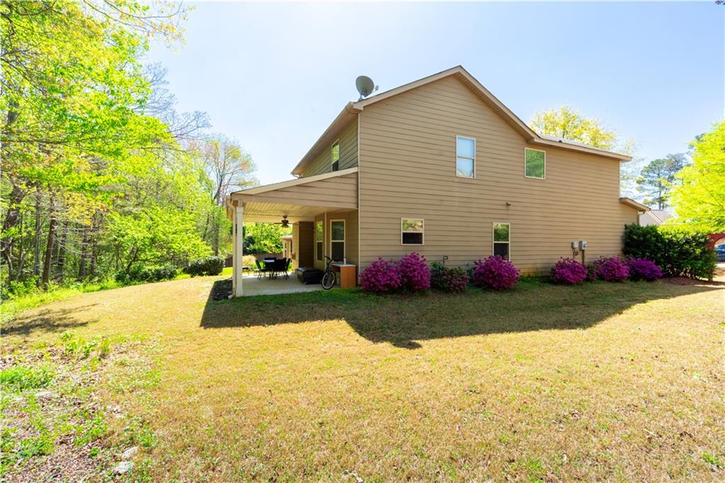 5555 Hedge Brook Drive Cumming, GA 30028 - Photo 15 of 15 a view of a house with a yard and a garden