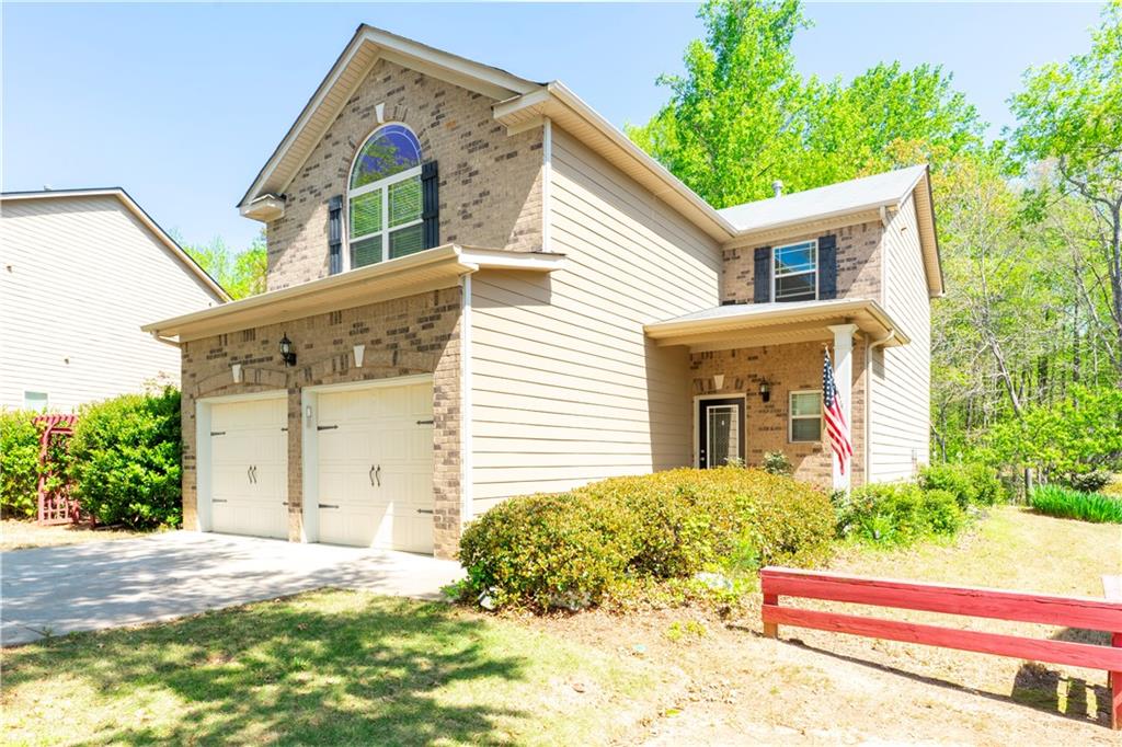 5555 Hedge Brook Drive Cumming, GA 30028 - Photo 2 of 15 a view of a house with backyard and trees