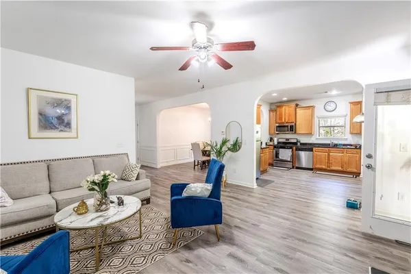 a living room with furniture and wooden floor