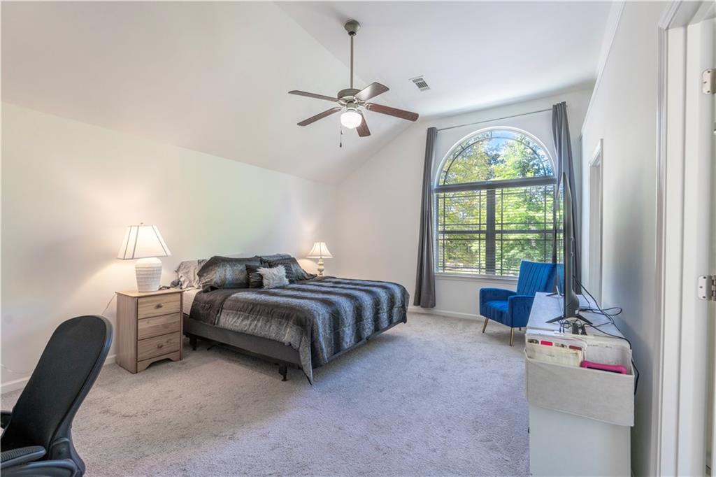 5555 Hedge Brook Drive Cumming, GA 30028 - Photo 8 of 15 a bedroom with bed and a large window