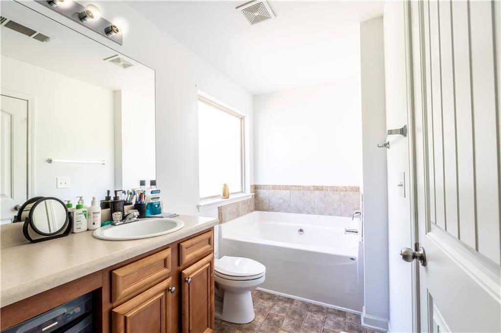 5555 Hedge Brook Drive Cumming, GA 30028 - Photo 9 of 15 a bathroom with a toilet a sink and a bathtub