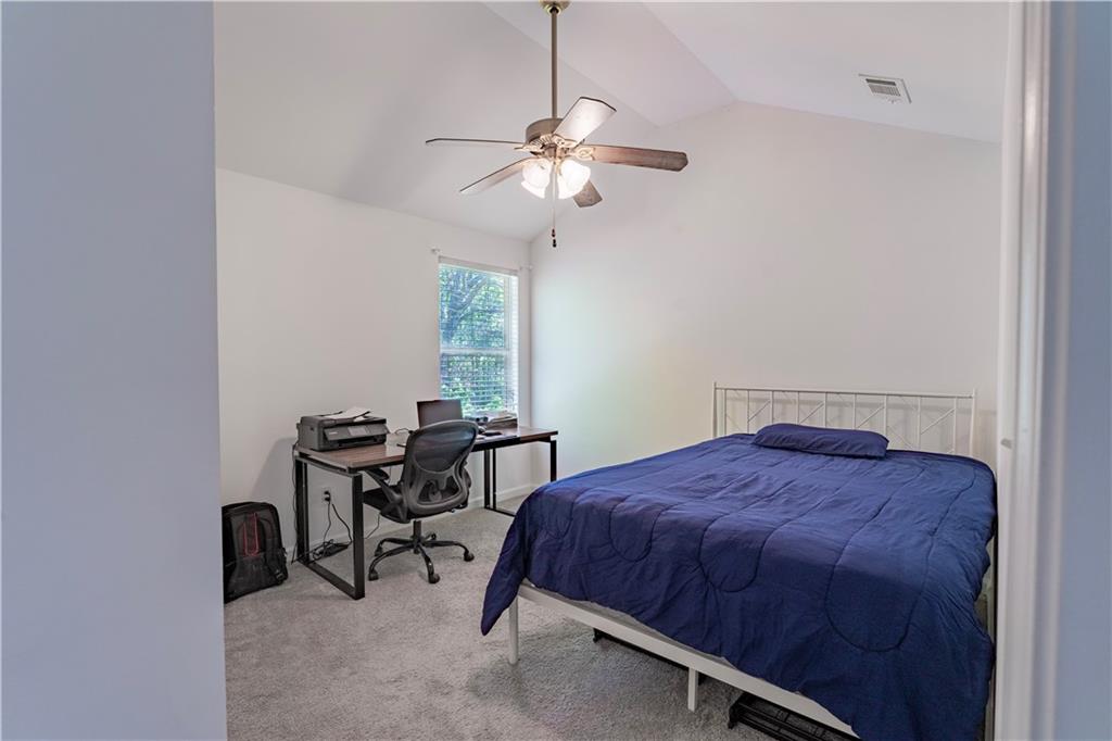 5555 Hedge Brook Drive Cumming, GA 30028 - Photo 10 of 15 a bedroom with a bed a desk and chair