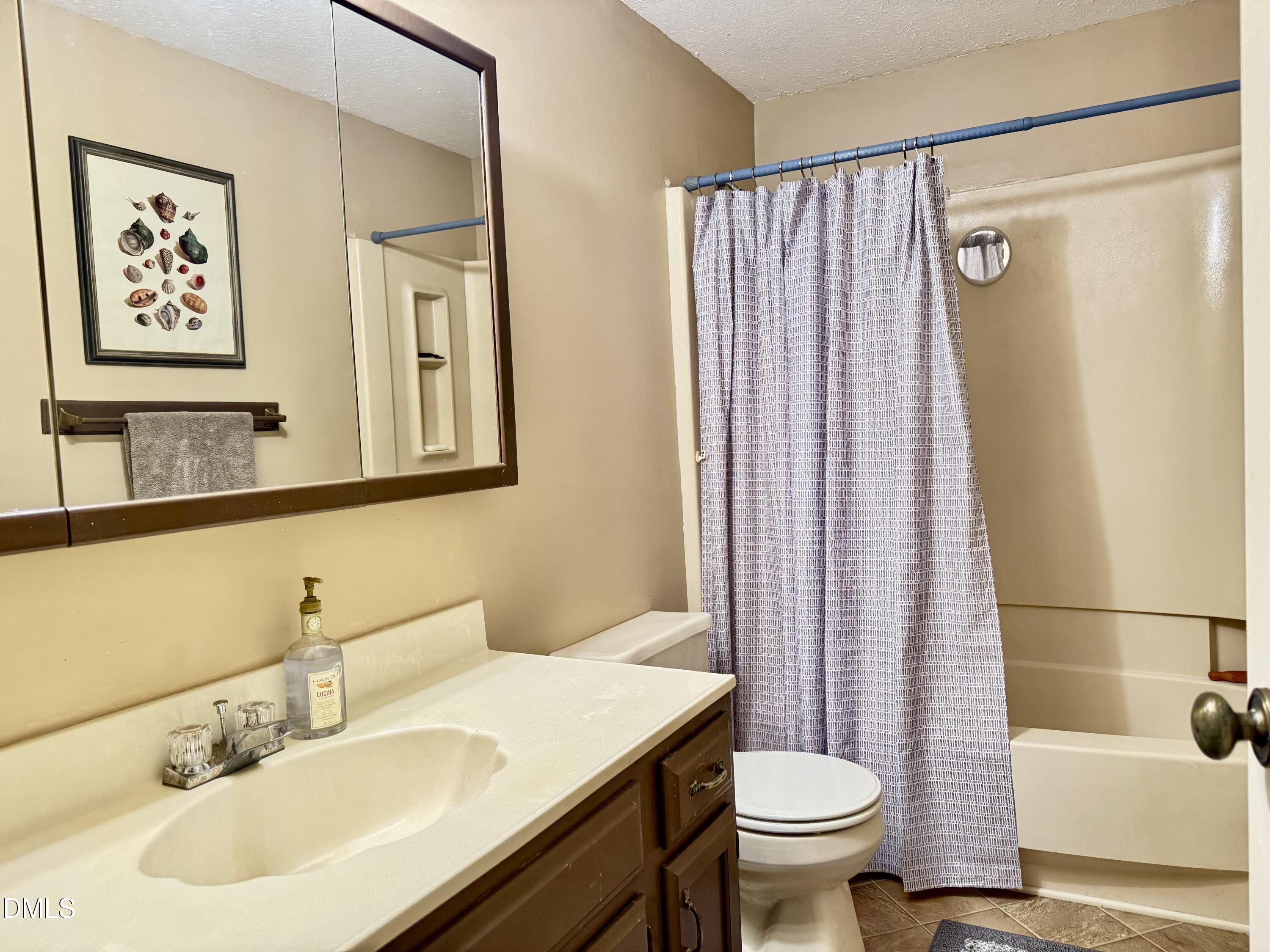 84 Wintergreen Road Henderson, NC 27537 - Photo 34 of 49 a bathroom with a sink toilet and shower