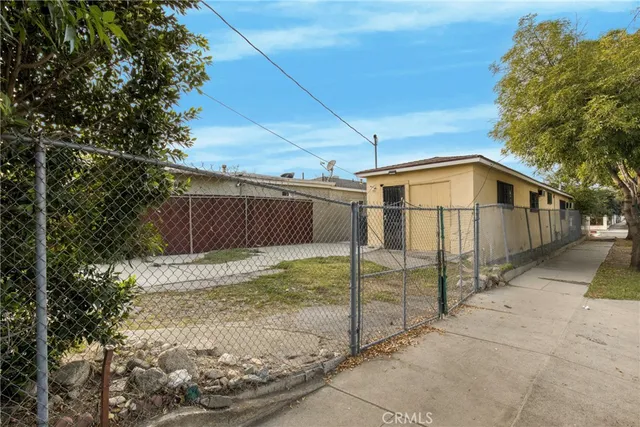 a view of a garden with a tree in the background