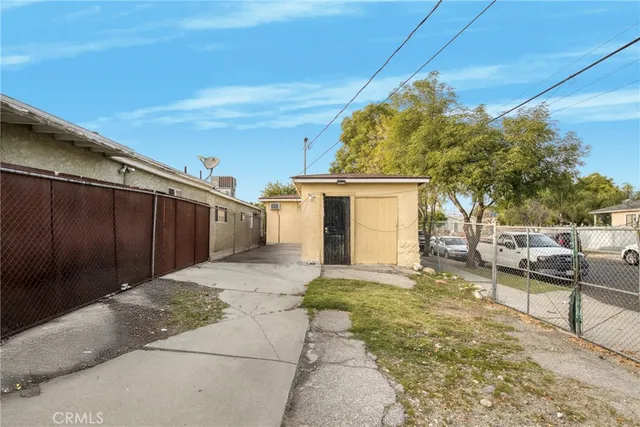 a view of a backyard with wooden fence