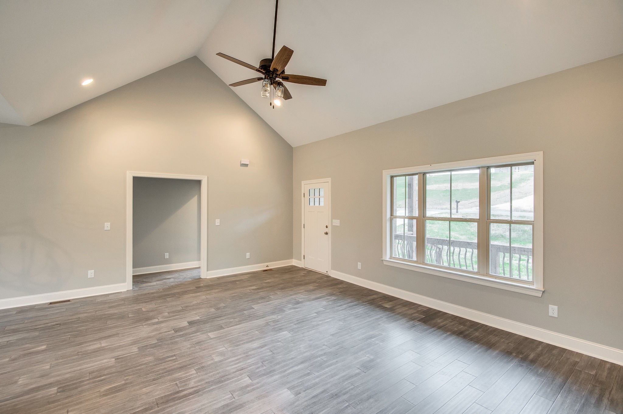 895 Goslin Branch Road Burns, TN 37029 - Photo 6 of 30 a view of an empty room with a window and wooden floor