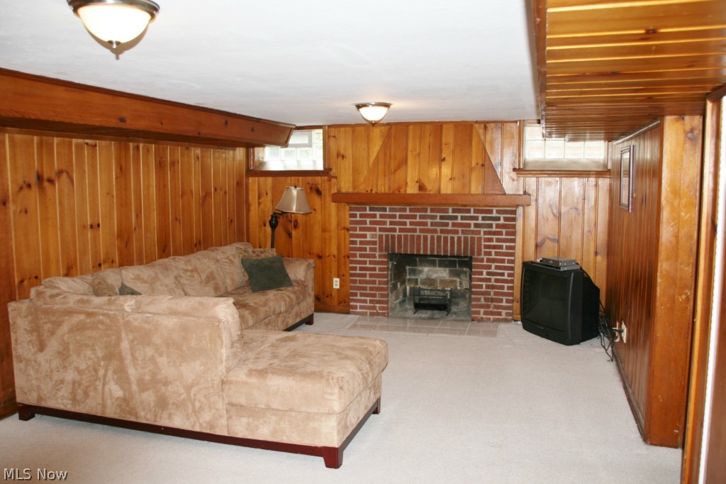 2452 Dysart Road Cleveland, OH 44118 - Photo 19 of 22 Retreat to the carpeted lower level family room for even more living space! Featuring knotty pine paneling, glass block windows, wood burning fireplace and built in bar.