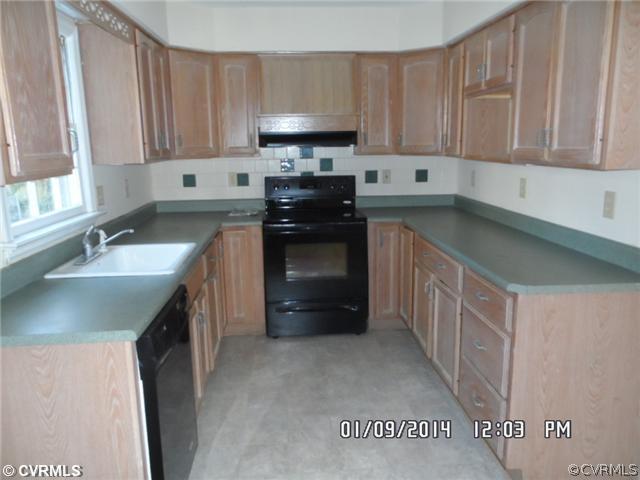 11124 Granada Road Richmond, VA 23235 - Photo 3 of 8 a kitchen with stainless steel appliances granite countertop a sink stove and refrigerator