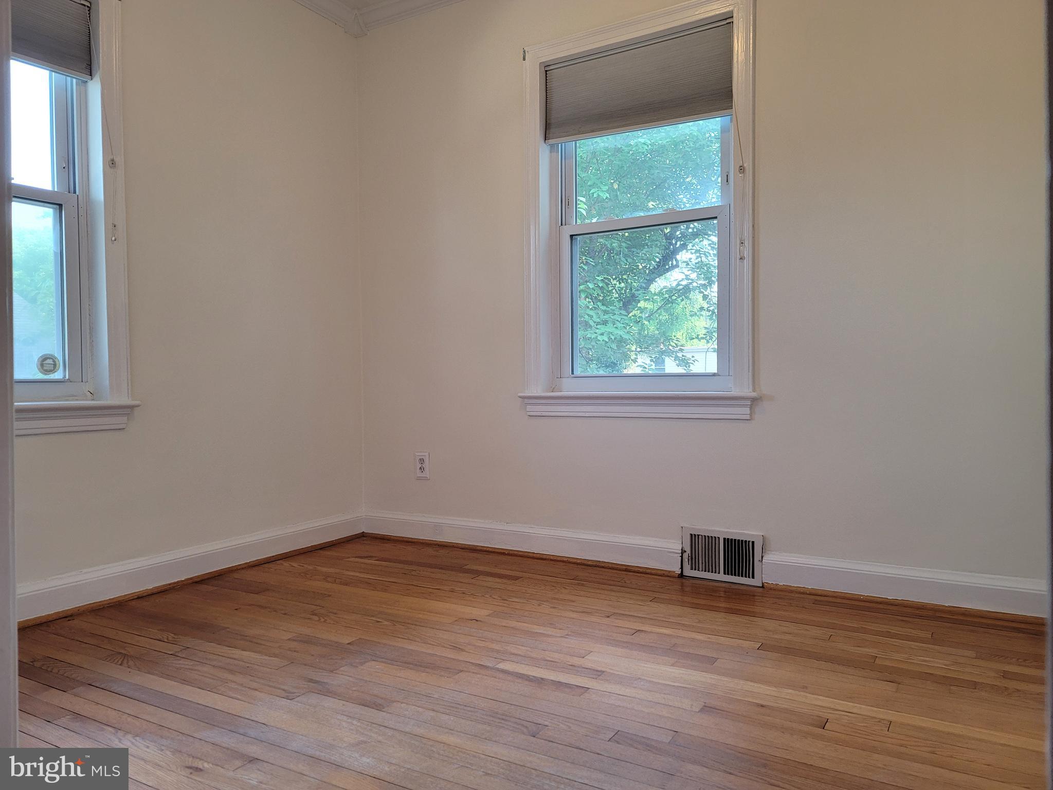 1015 Veirs Mill Road Rockville, MD 20851 - Photo 15 of 57 an empty room with wooden floor and a window