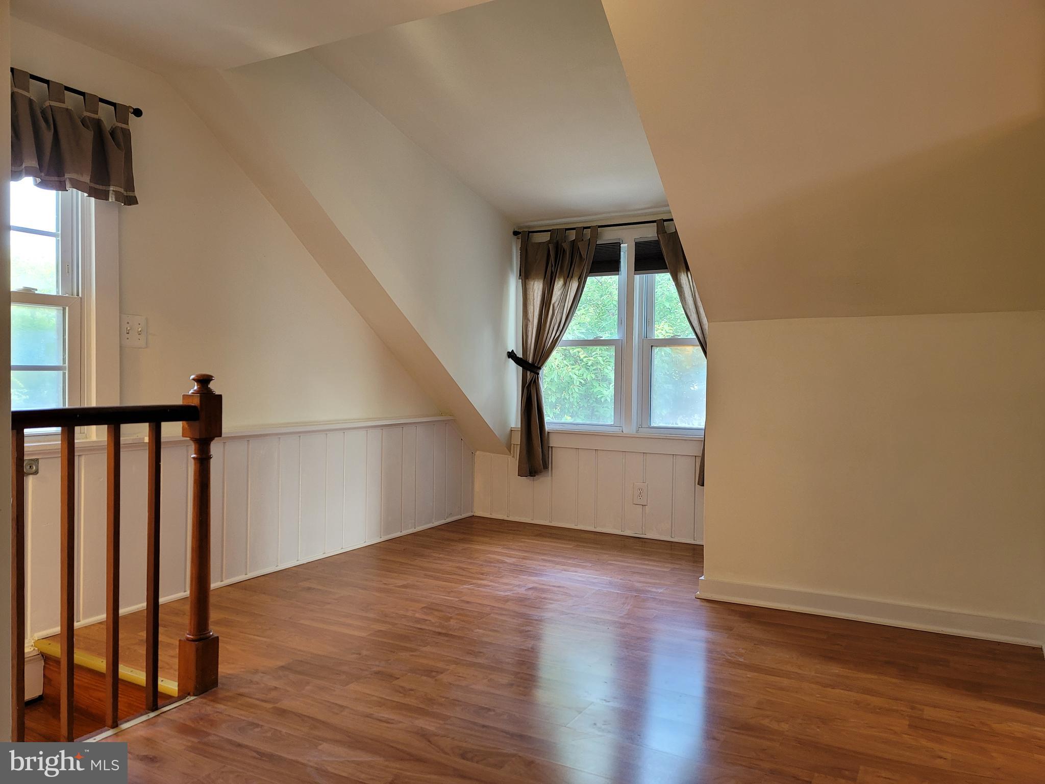 1015 Veirs Mill Road Rockville, MD 20851 - Photo 19 of 57 wooden floor in an empty room with a window