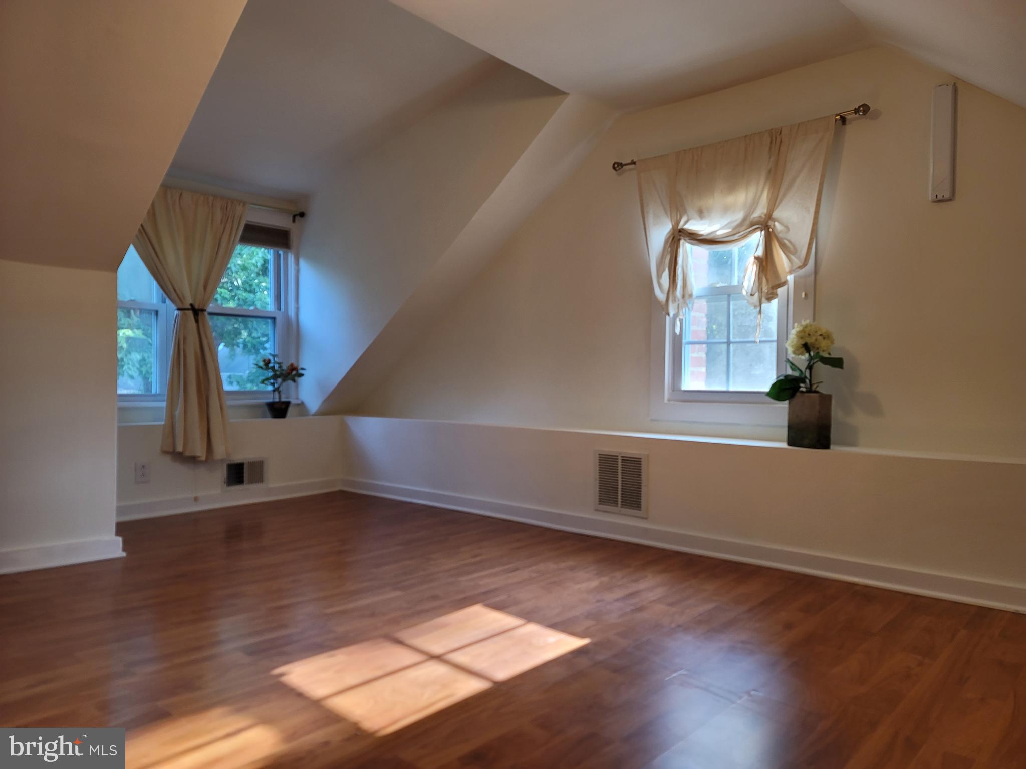 1015 Veirs Mill Road Rockville, MD 20851 - Photo 21 of 57 a view of an empty room with wooden floor and a window