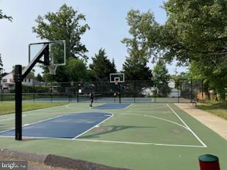 1015 Veirs Mill Road Rockville, MD 20851 - Photo 55 of 57 a tennis court view covered with trees in the background