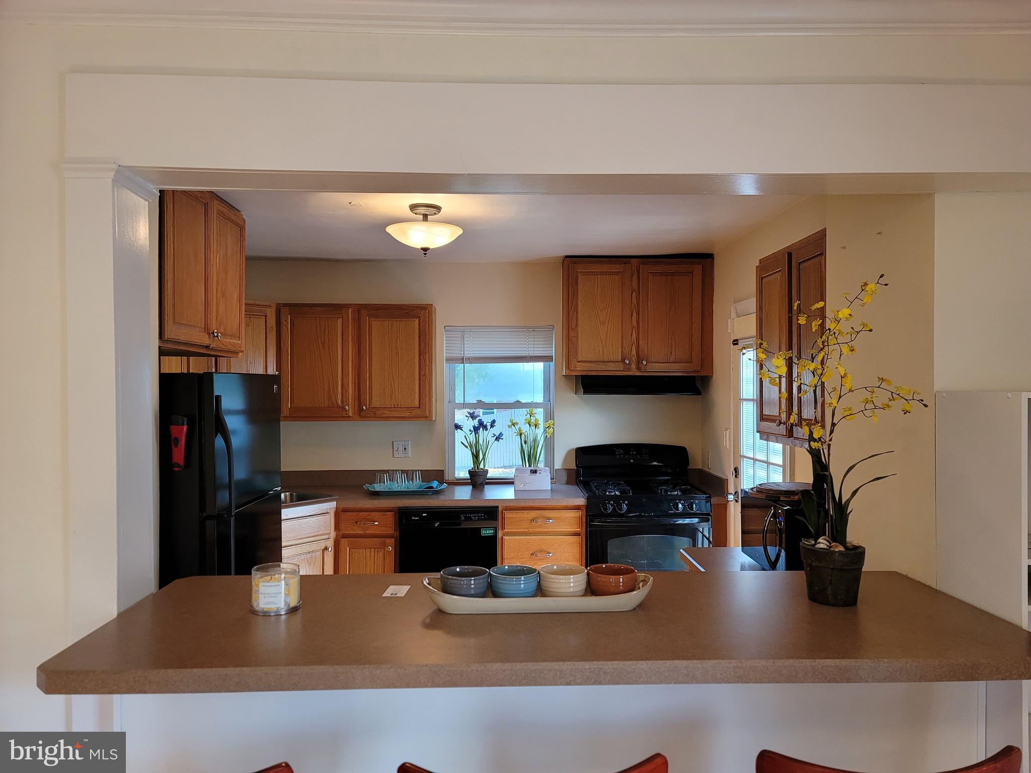 1015 Veirs Mill Road Rockville, MD 20851 - Photo 8 of 57 a kitchen with a table chairs and a refrigerator