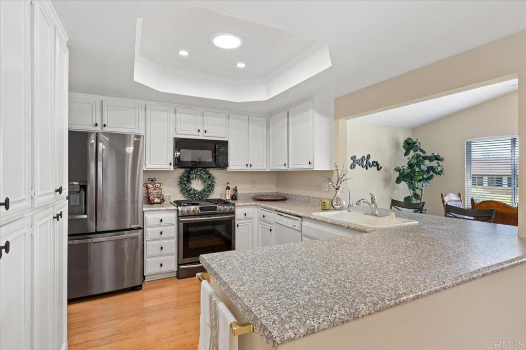 1277 La Casa Drive San Marcos, CA 92078 - Photo 14 of 29 a kitchen with granite countertop a refrigerator a sink a stove a microwave and island