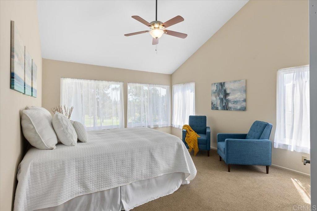 1277 La Casa Drive San Marcos, CA 92078 - Photo 17 of 29 a bedroom with a bed a couch and a large window with the potted plants