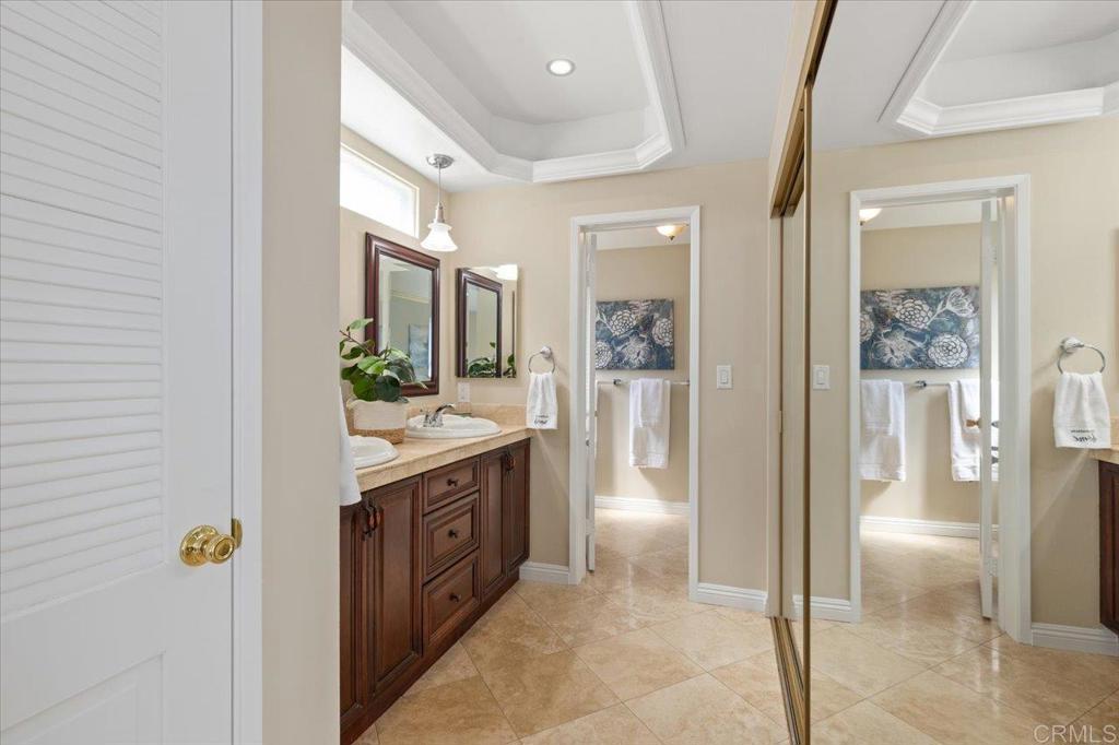 1277 La Casa Drive San Marcos, CA 92078 - Photo 19 of 29 a bathroom with a double vanity sink and a mirror