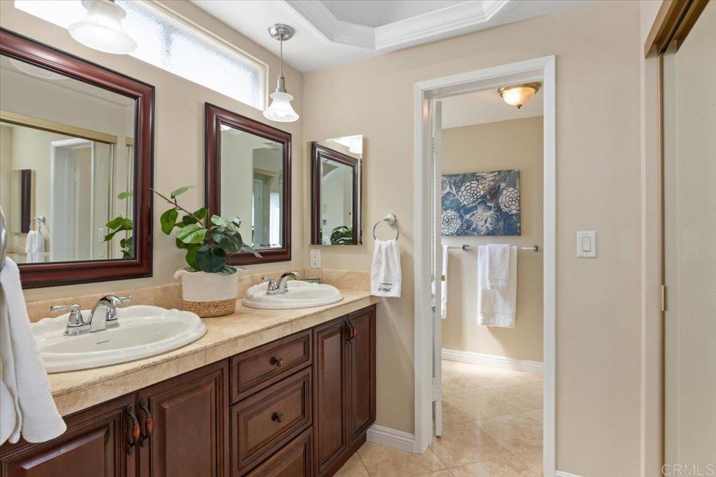 1277 La Casa Drive San Marcos, CA 92078 - Photo 20 of 29 a bathroom with double vanity sinks a mirror and a shower