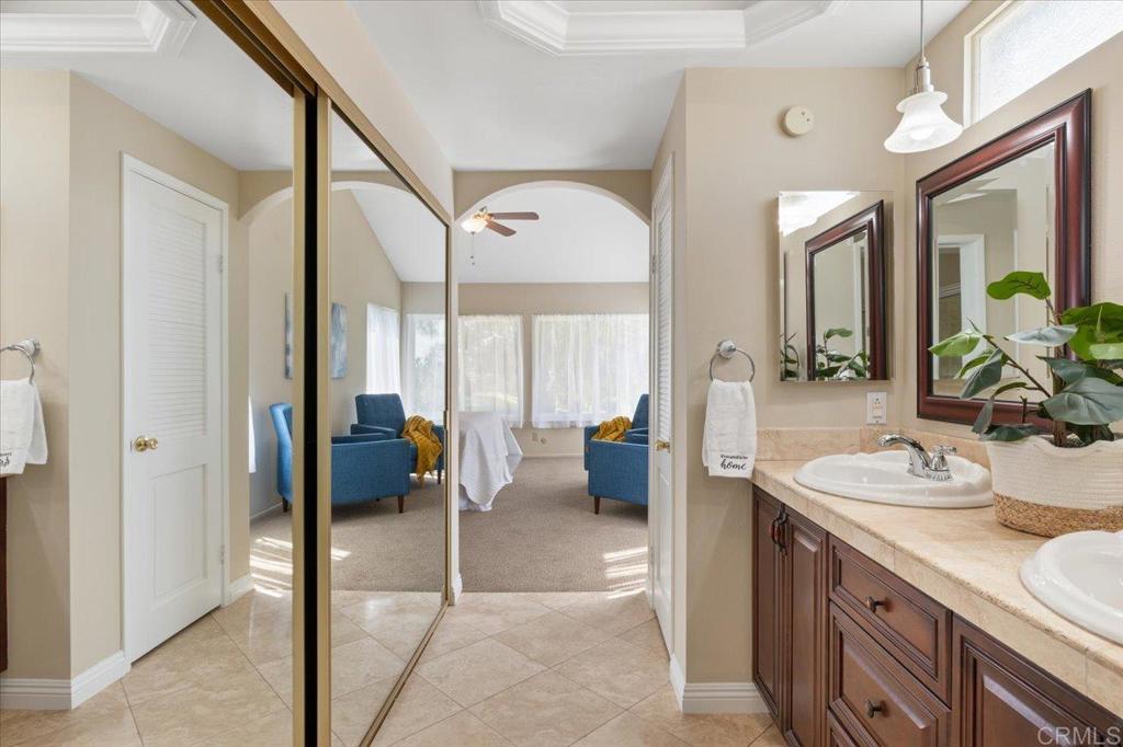 1277 La Casa Drive San Marcos, CA 92078 - Photo 21 of 29 a spacious bathroom with a double vanity sink and a mirror