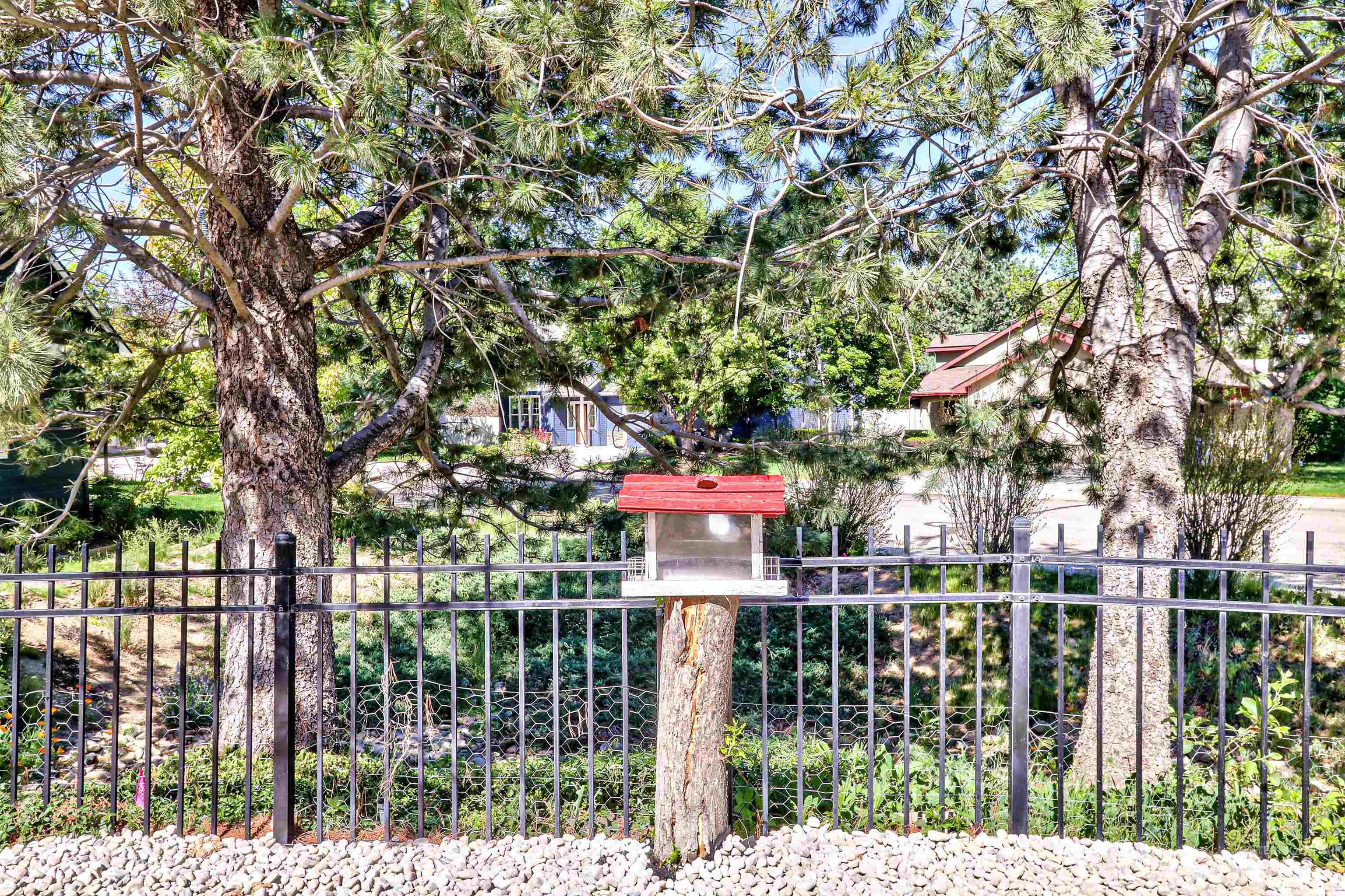 892 South Capitola Way Boise, ID 83712 - Photo 32 of 34 Mature trees framing the property, featuring a black metal fence
