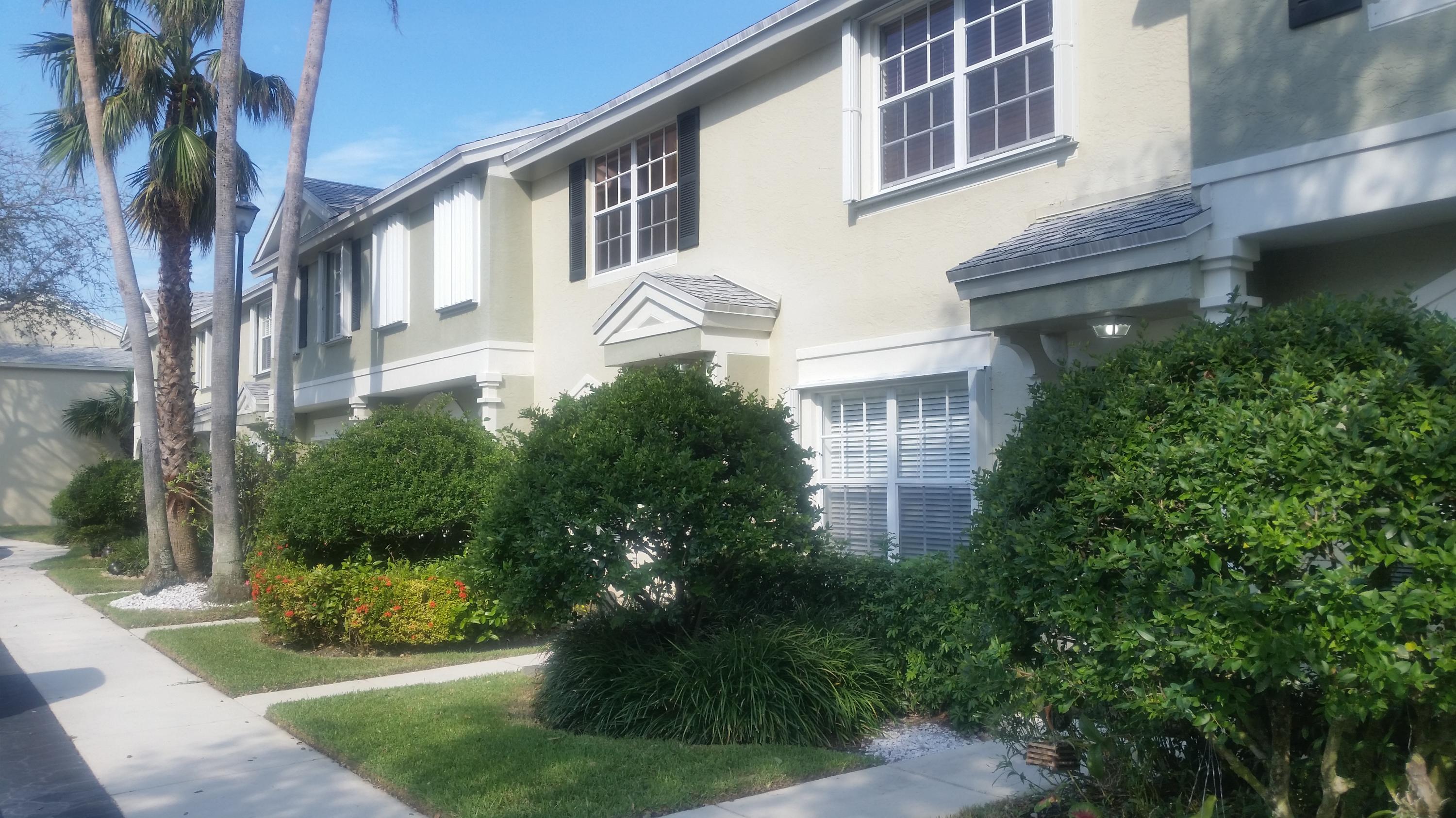 1004 Kokomo Key Lane Delray Beach, FL 33483 - Photo 1 of 21 a front view of a house with garden