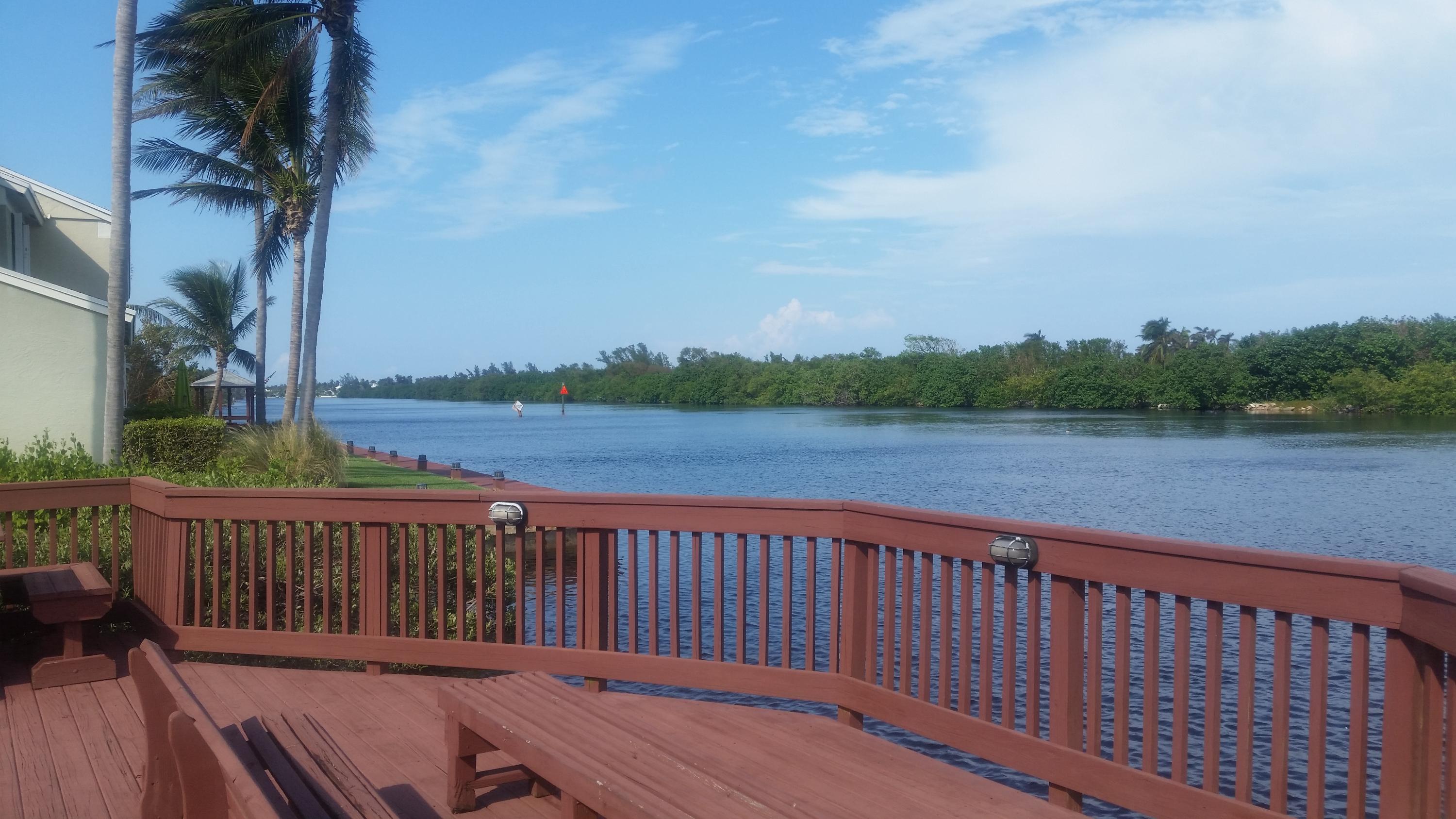 1004 Kokomo Key Lane Delray Beach, FL 33483 - Photo 17 of 21 a balcony with wooden floor and fence