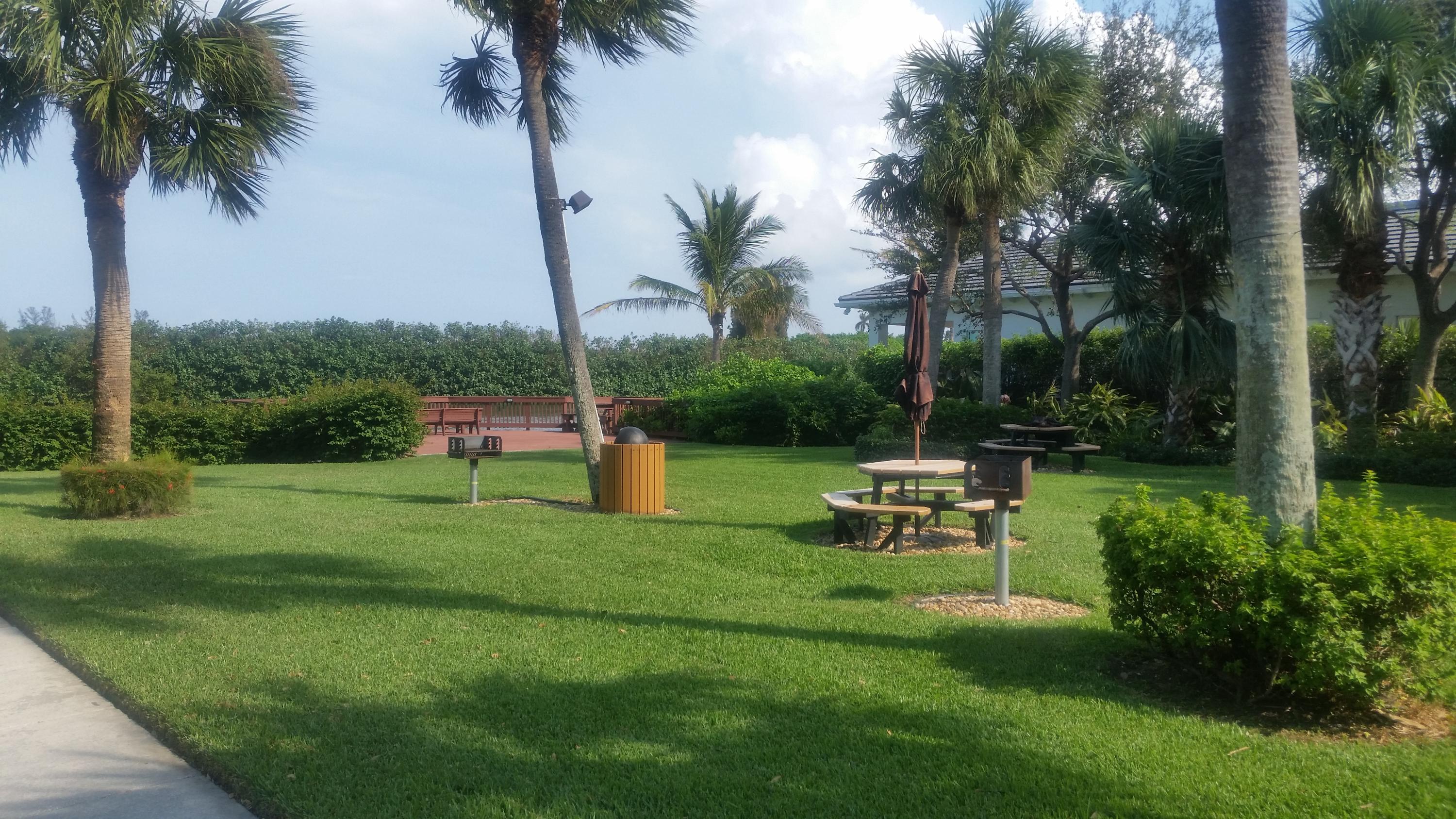 1004 Kokomo Key Lane Delray Beach, FL 33483 - Photo 18 of 21 a view of a table and chairs in the garden