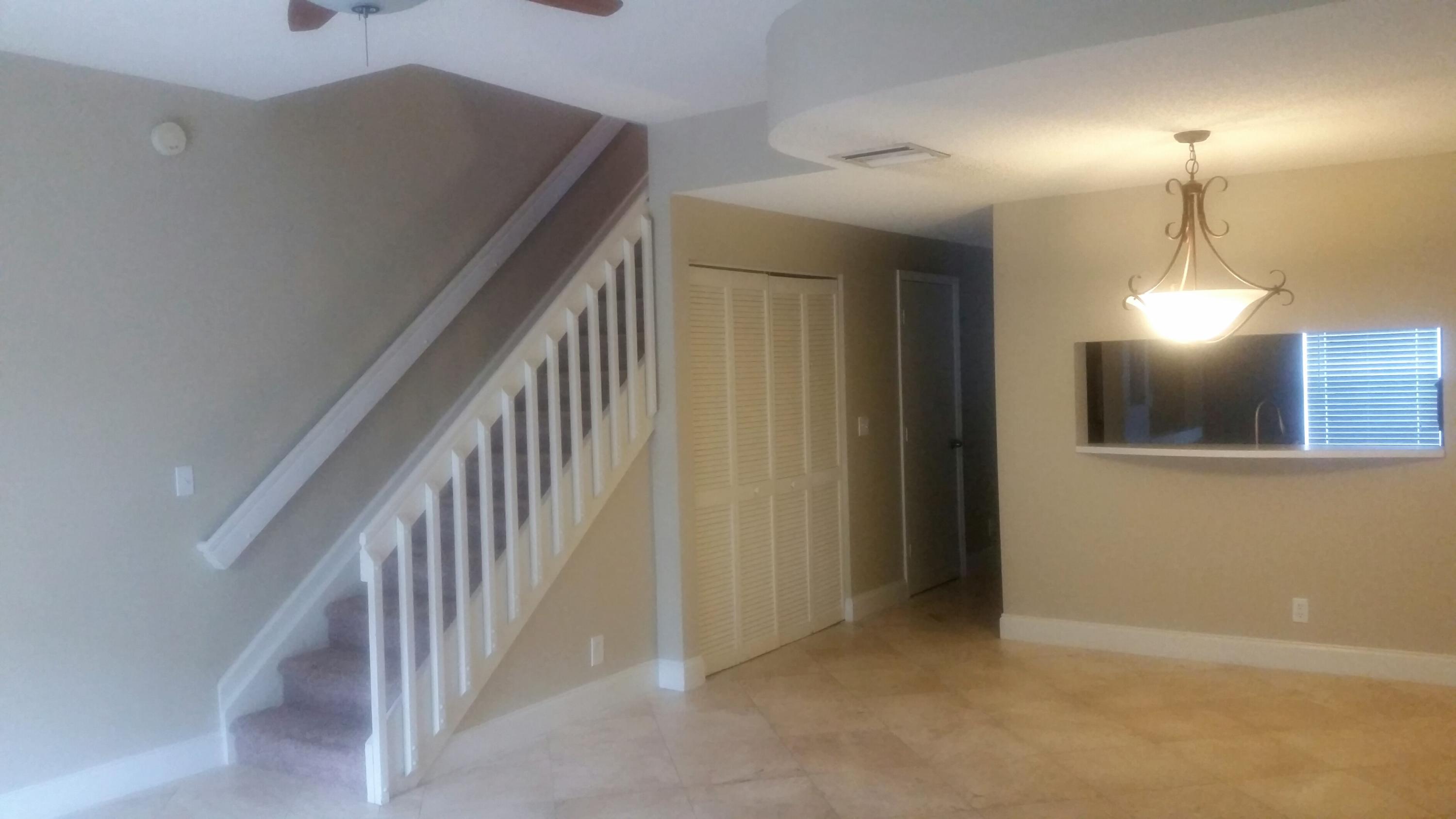 1004 Kokomo Key Lane Delray Beach, FL 33483 - Photo 4 of 21 a view of a hallway with staircase