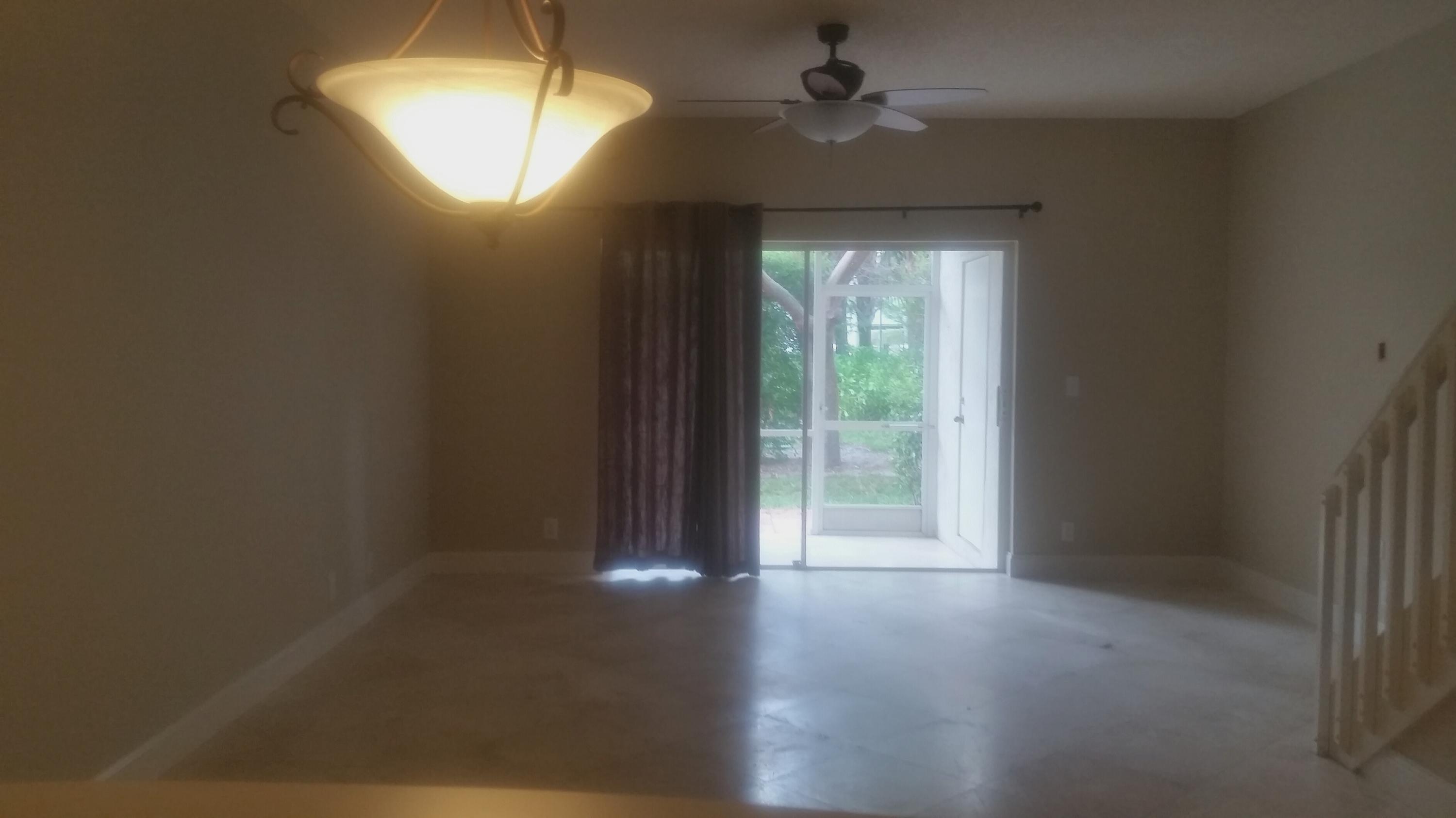 1004 Kokomo Key Lane Delray Beach, FL 33483 - Photo 6 of 21 a view of empty room with wooden floor and fan