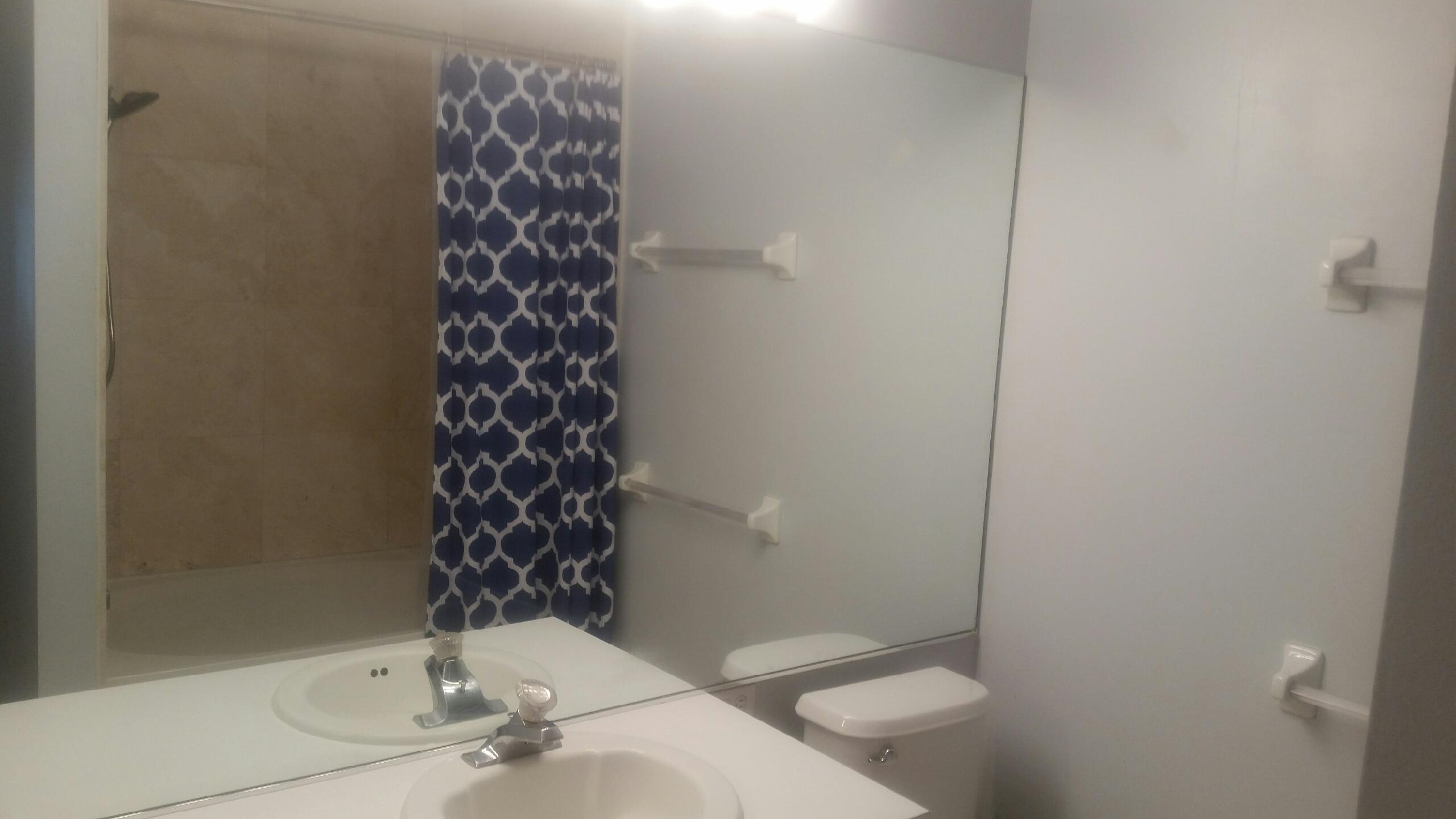 1004 Kokomo Key Lane Delray Beach, FL 33483 - Photo 10 of 21 a bathroom with a sink a toilet and shower
