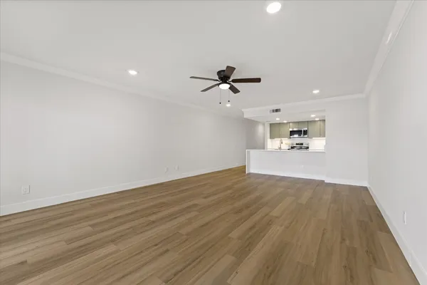 a bedroom with a large bed and a ceiling fan