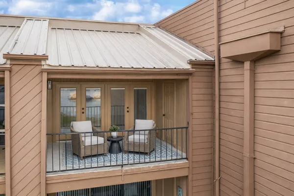 a front view of residential houses with cars parked