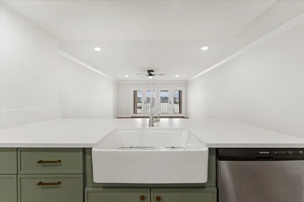 a kitchen with stainless steel appliances a stove microwave and sink