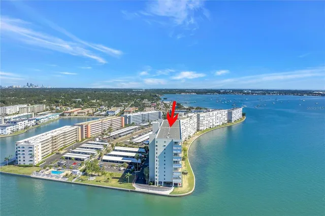 a view of swimming pool with outdoor seating and city view