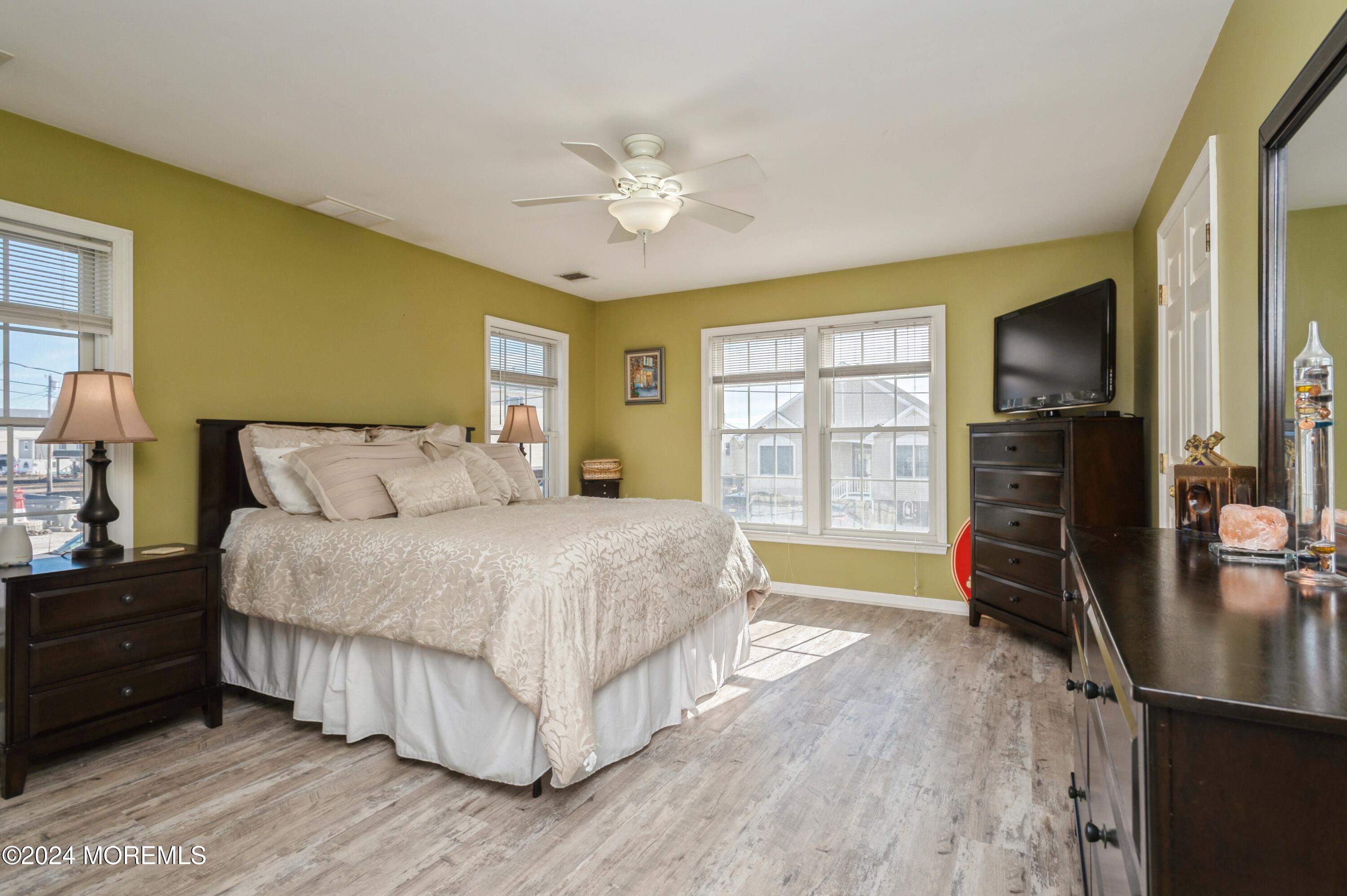 115 Curlew Road Tuckerton, NJ 08087 - Photo 13 of 36 a bedroom with a bed and wooden floor