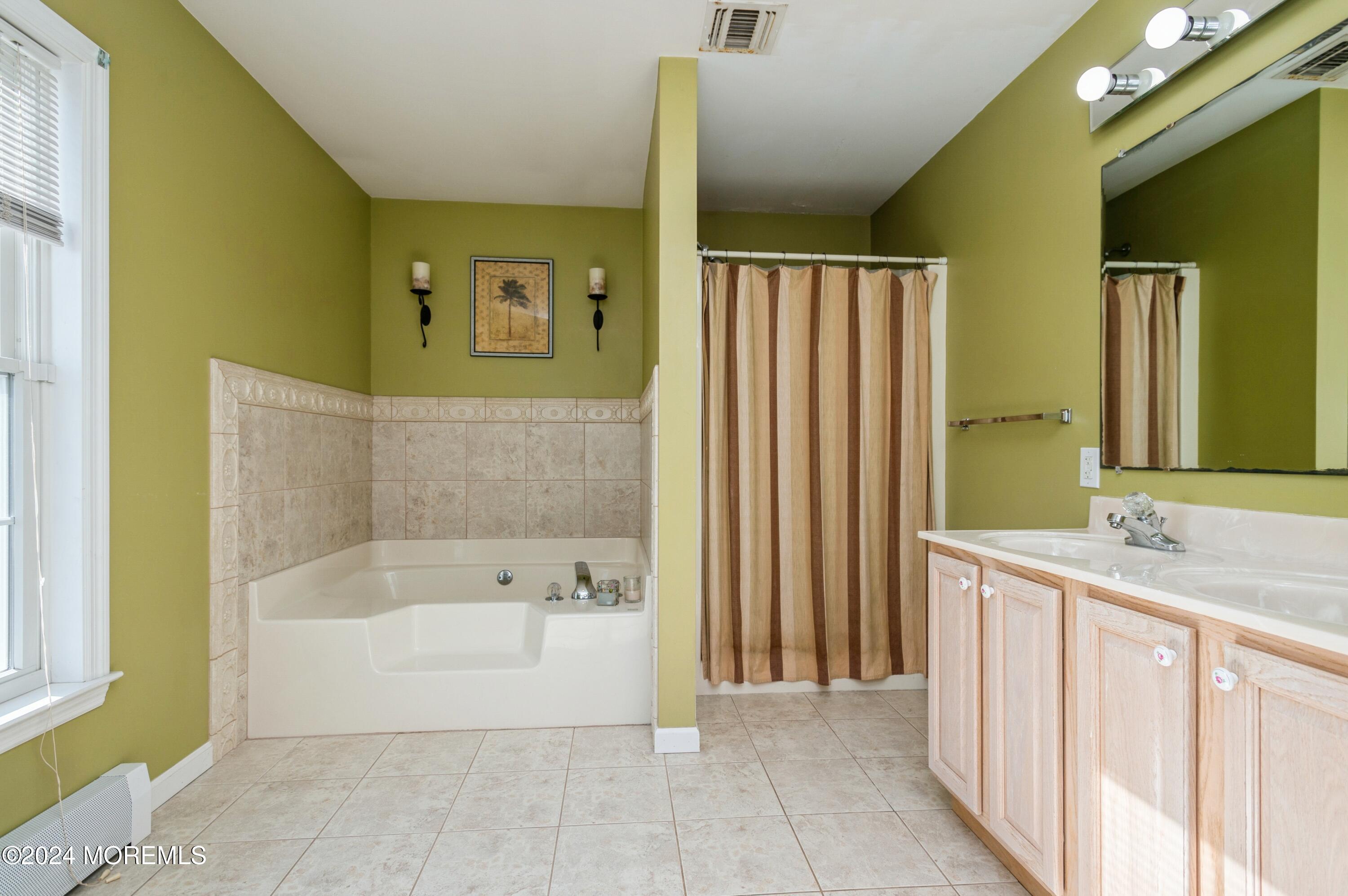 115 Curlew Road Tuckerton, NJ 08087 - Photo 14 of 36 a bathroom with a bathtub and a sink