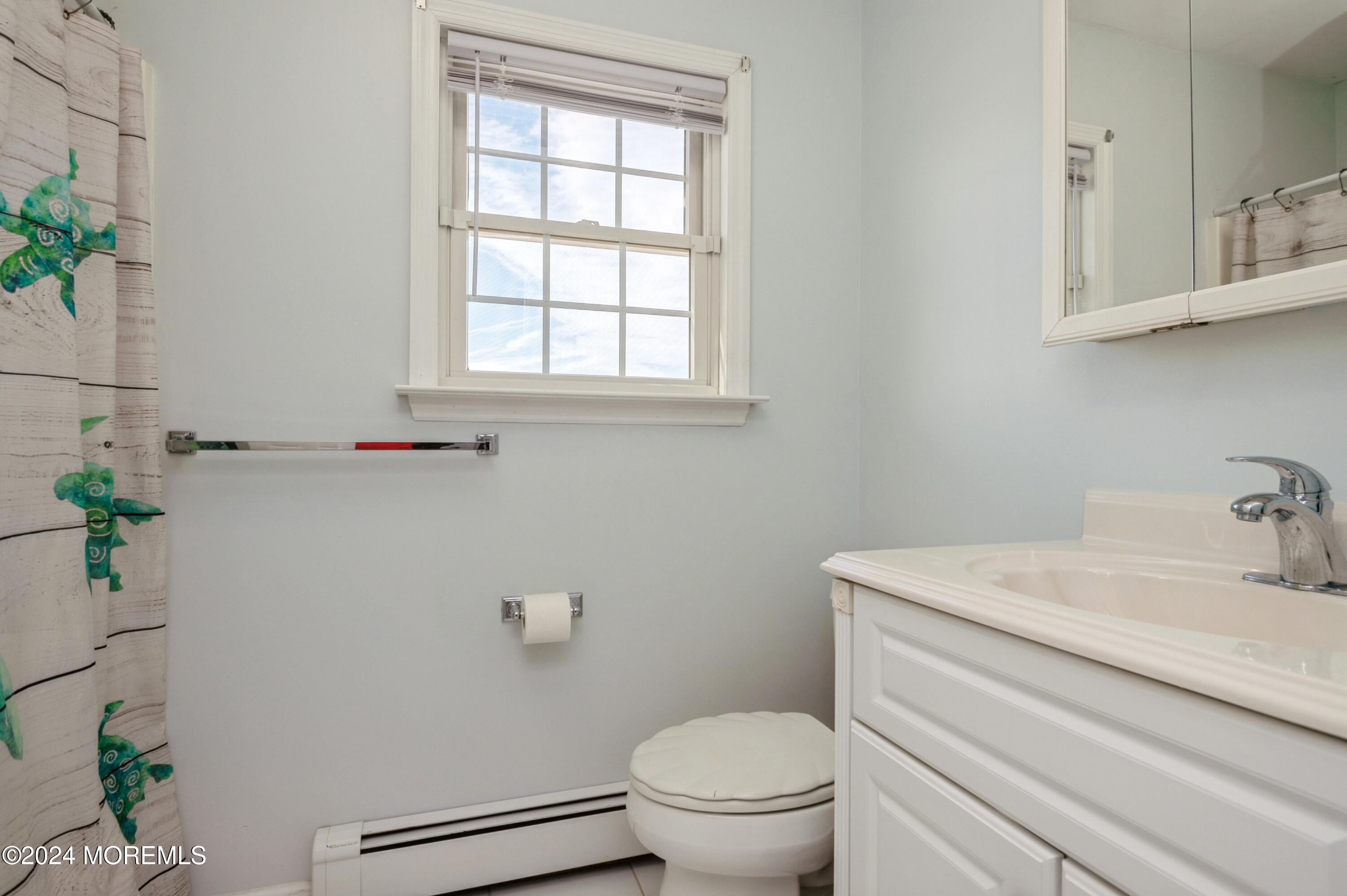115 Curlew Road Tuckerton, NJ 08087 - Photo 18 of 36 a bathroom with a sink a toilet and a window