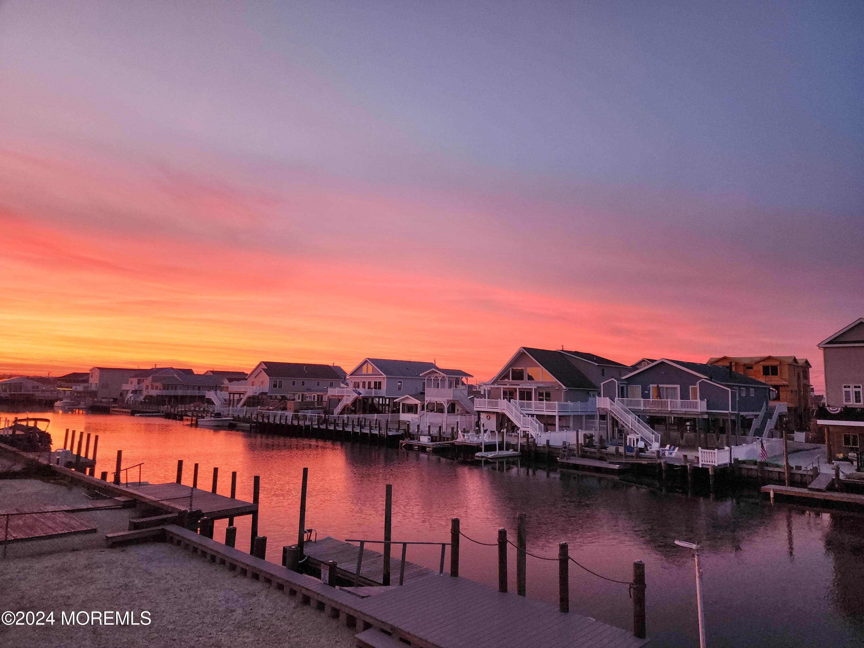 115 Curlew Road Tuckerton, NJ 08087 - Photo 36 of 36 a view of a lake with a table under an umbrella