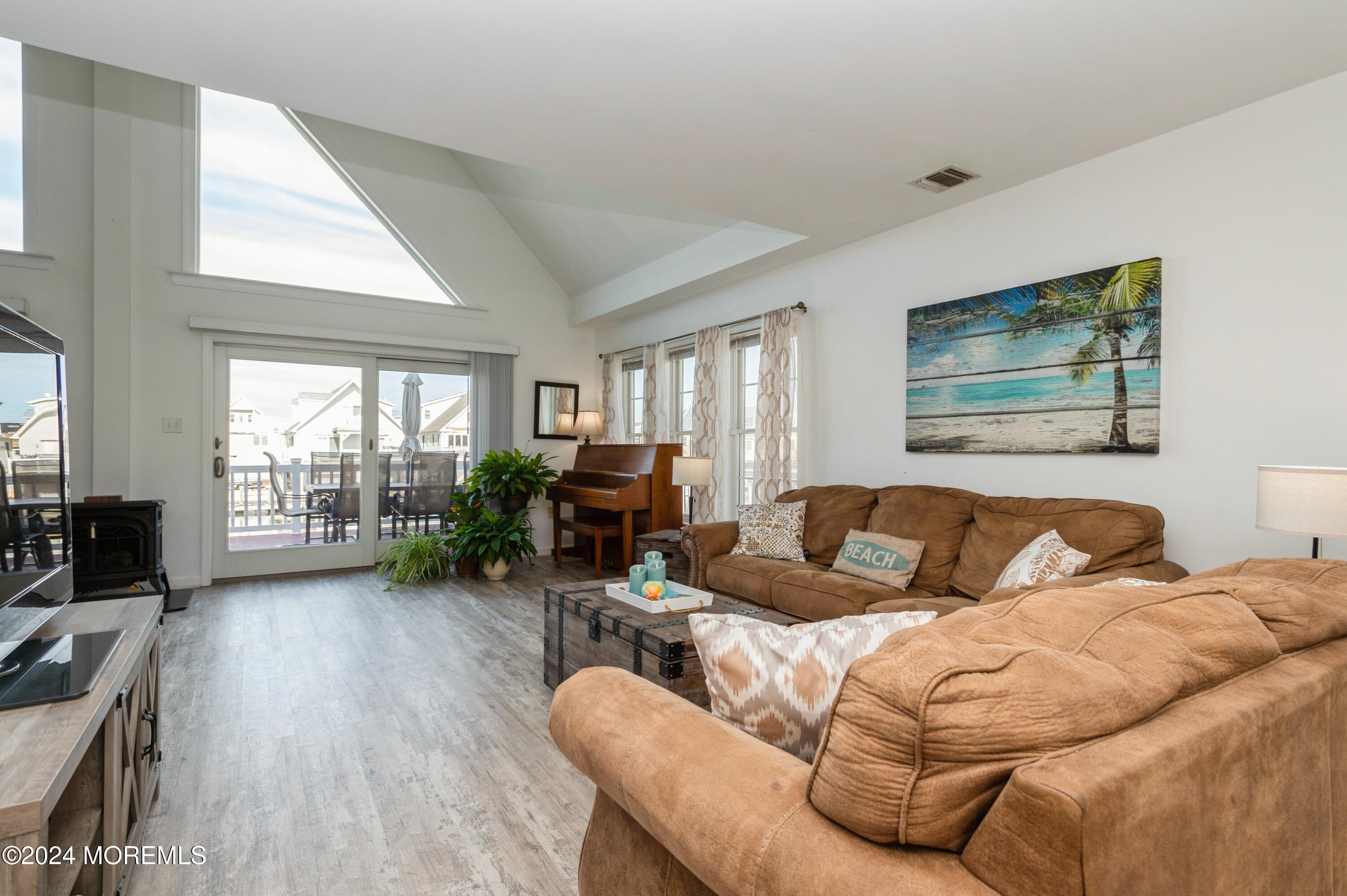 115 Curlew Road Tuckerton, NJ 08087 - Photo 4 of 36 a living room with furniture large window and a flat screen tv