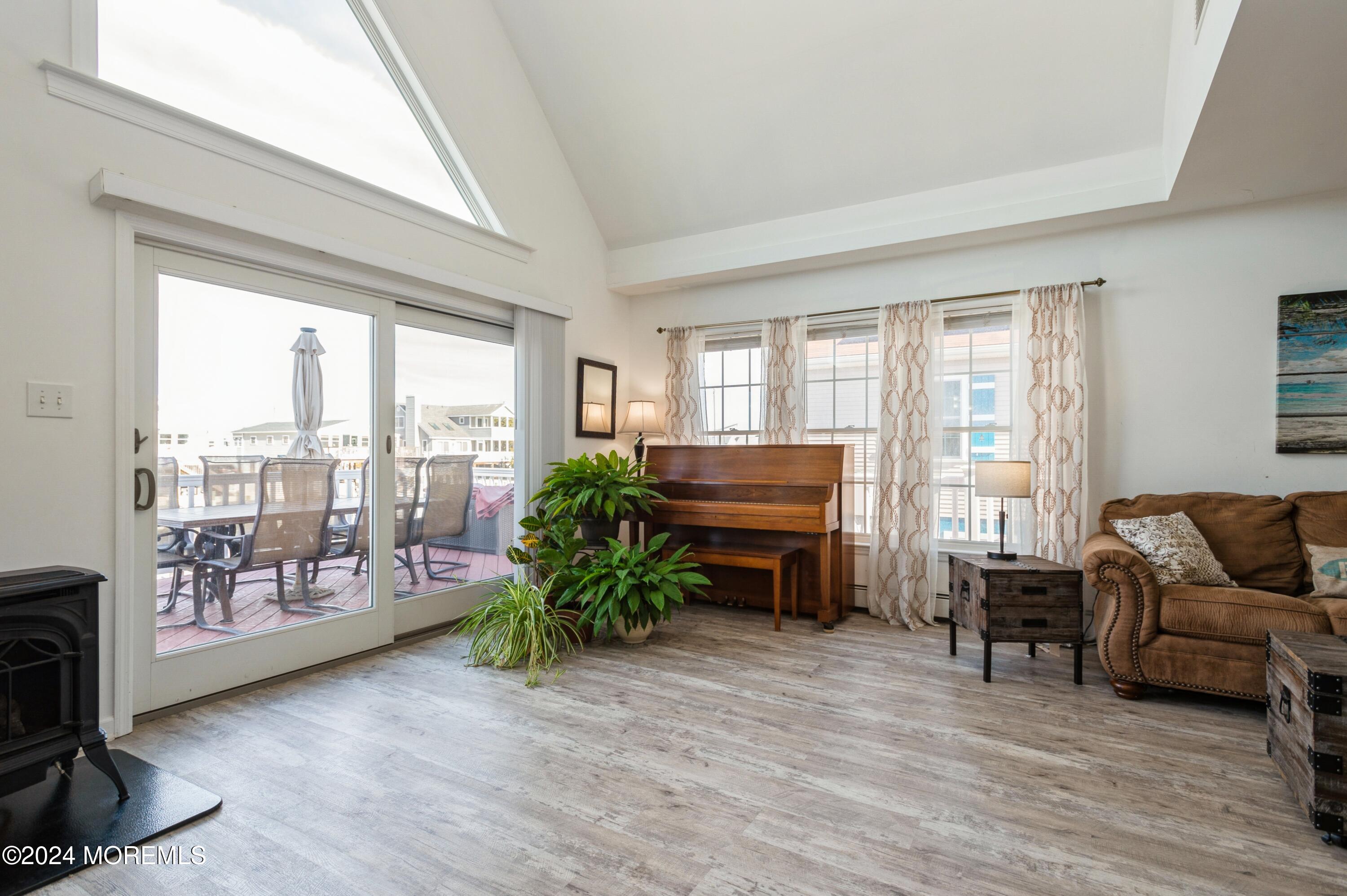 115 Curlew Road Tuckerton, NJ 08087 - Photo 6 of 36 a living room with furniture and a floor to ceiling window
