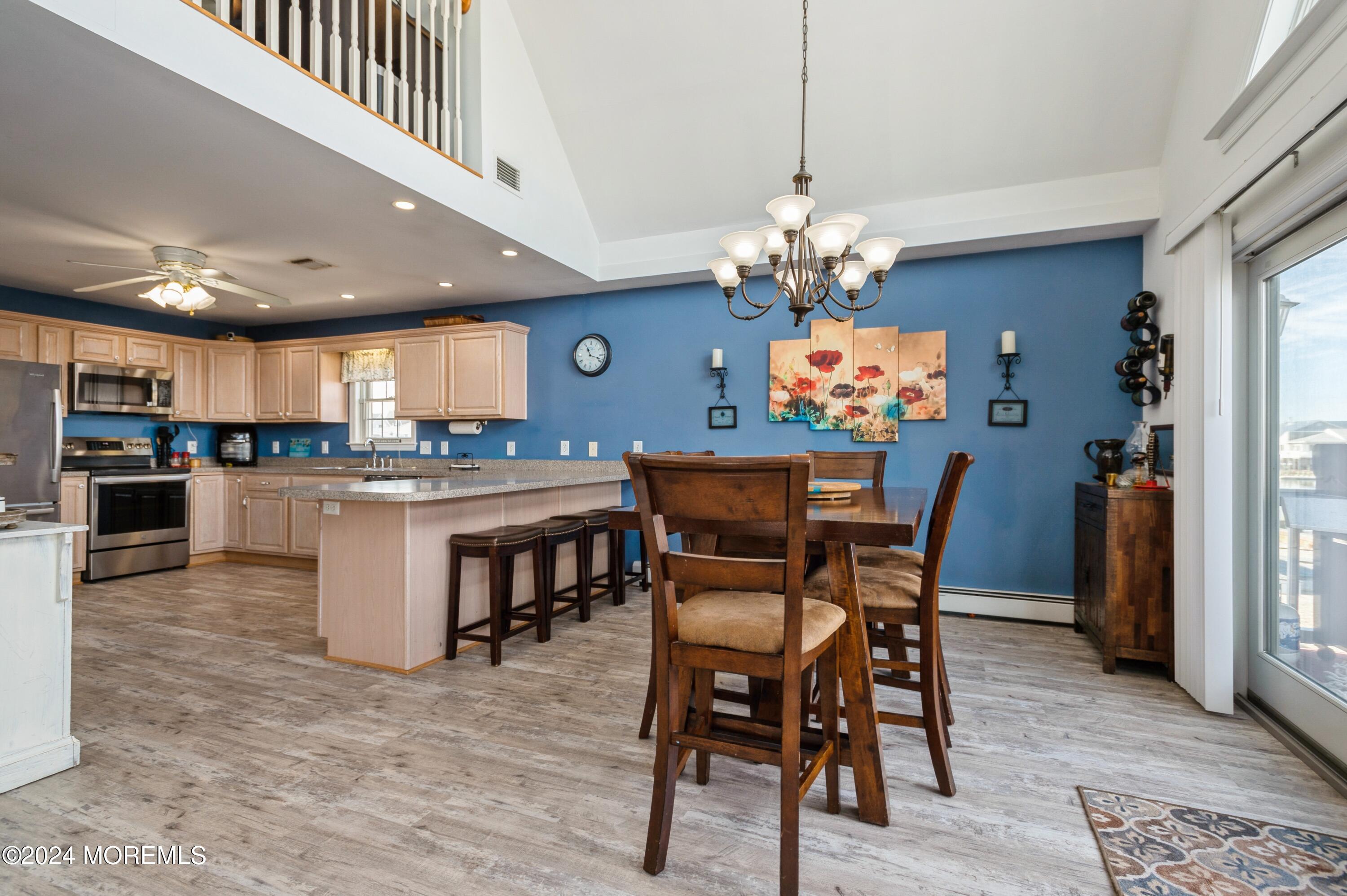 115 Curlew Road Tuckerton, NJ 08087 - Photo 7 of 36 a dining room filled chandelier and kitchen view