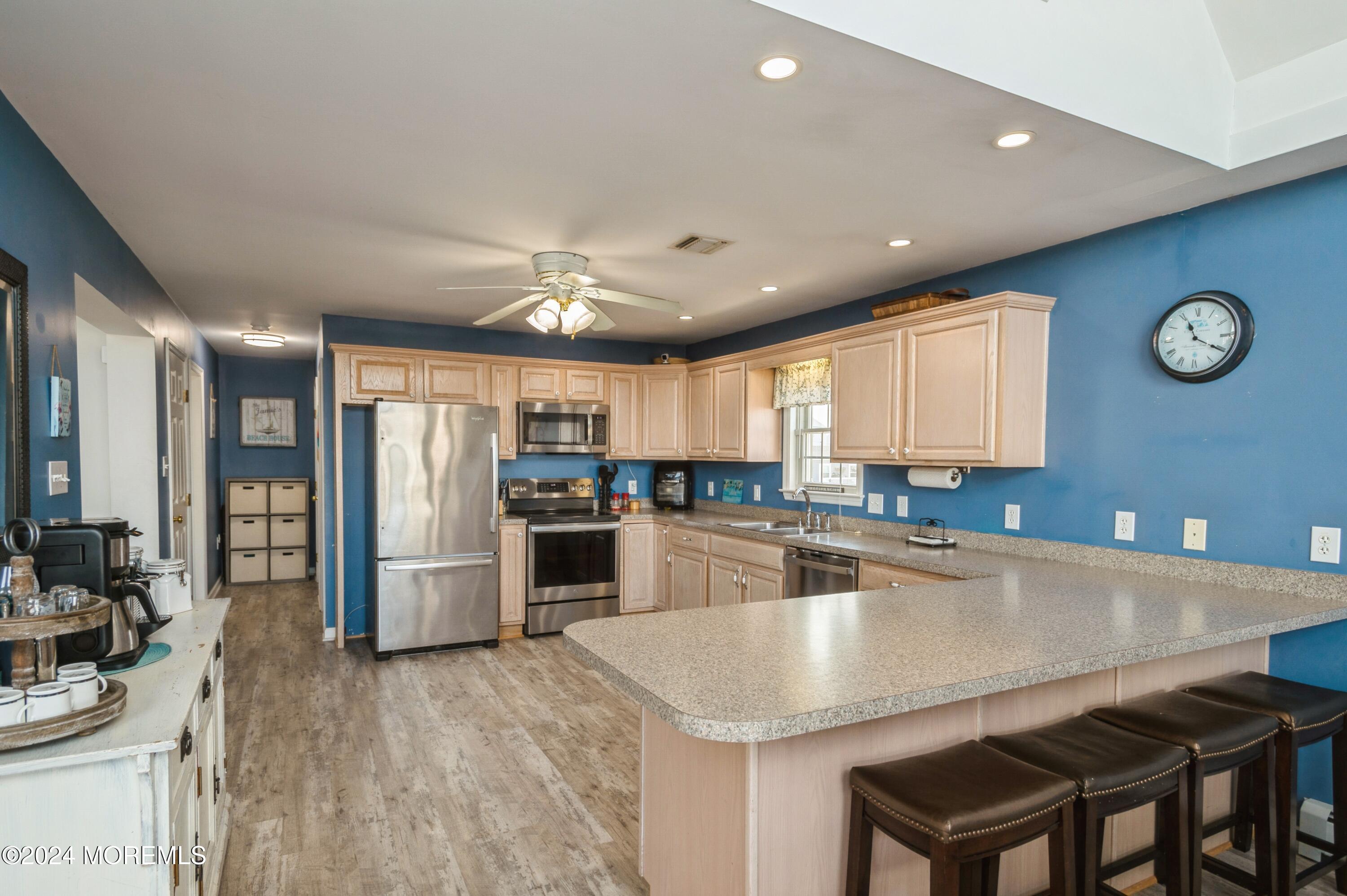 115 Curlew Road Tuckerton, NJ 08087 - Photo 9 of 36 a kitchen with a table chairs refrigerator and cabinets