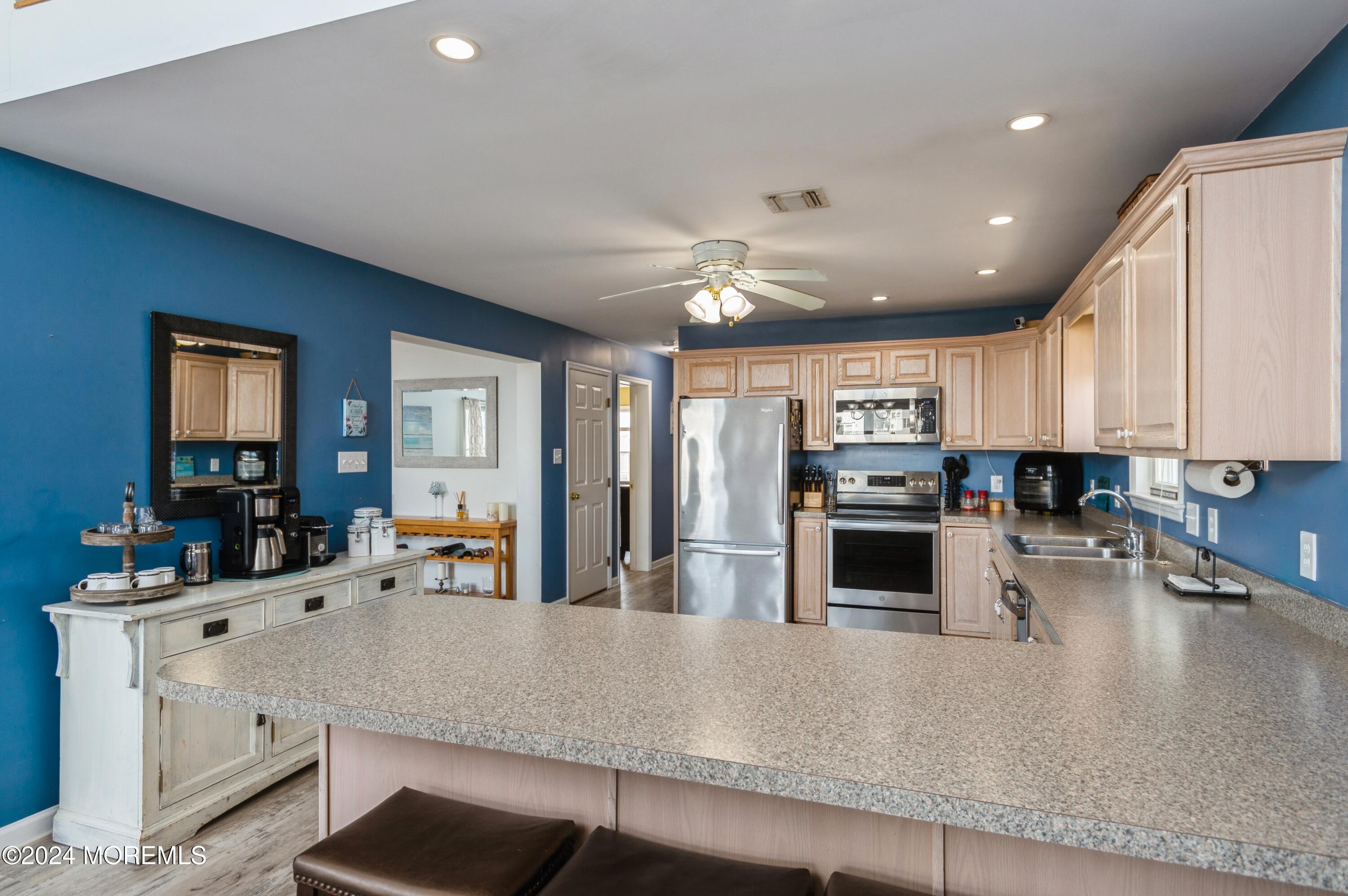 115 Curlew Road Tuckerton, NJ 08087 - Photo 10 of 36 a large kitchen with stainless steel appliances and a large window