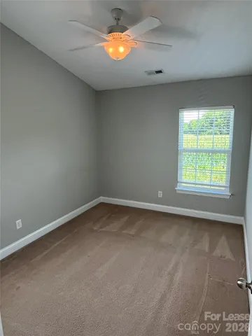 an empty room with a window and a fireplace