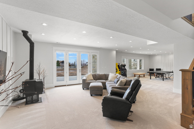 1354 South 800 East Mapleton, UT 84664 - Photo 72 of 129 area with a textured ceiling, light colored carpet, recessed lighting, a wood stove, and french doors